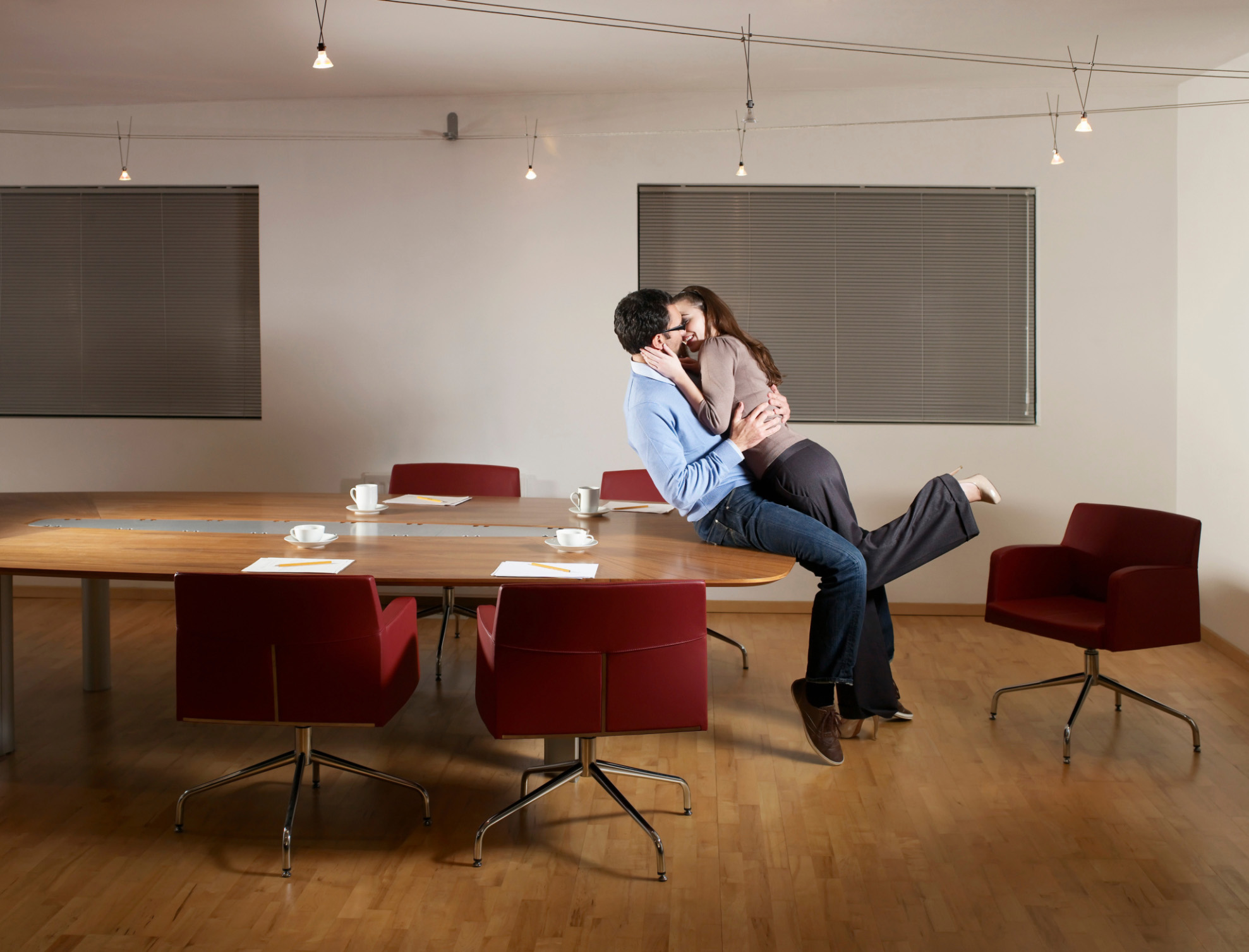 Man and woman kissing in office